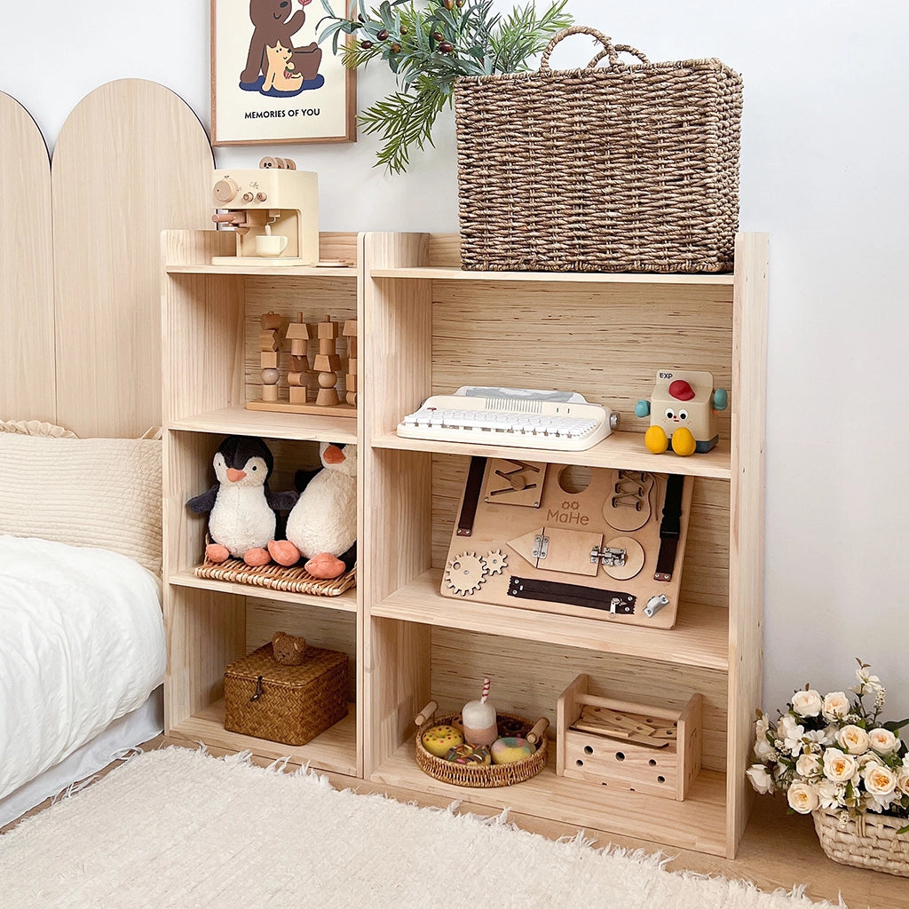 Solid pine toddler storage shelf with a large woven basket on the top shelf next to a bed