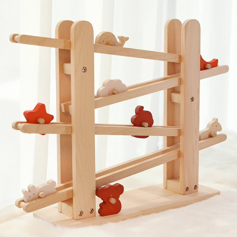 Angled view of a solid beech Montessori animal flip track toy with colorful wooden characters on its ramps