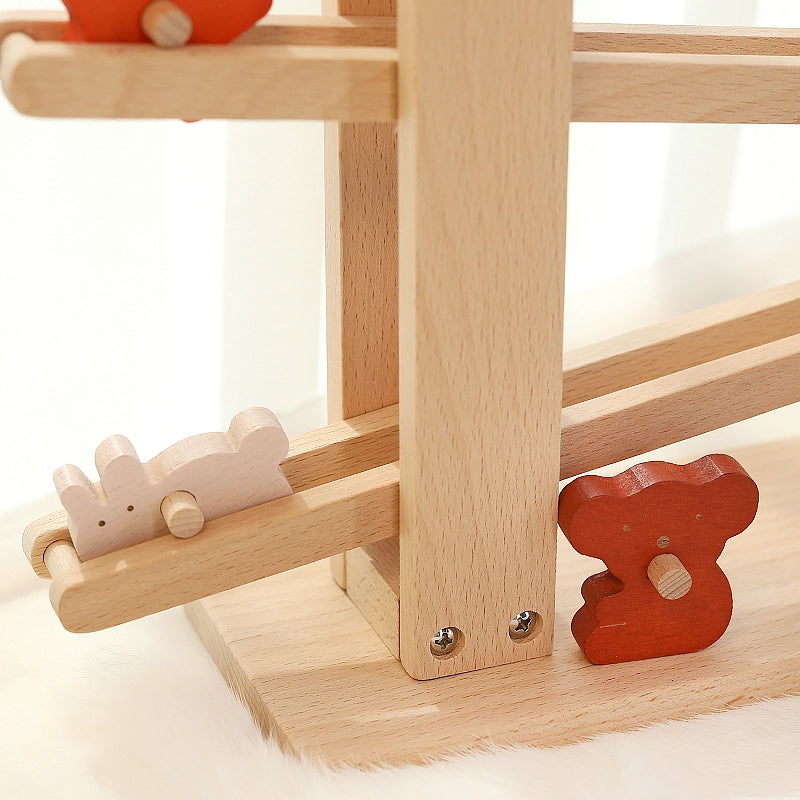 Close-up of a white rabbit block sliding down the bottom tier of a solid beech wooden flip track toy