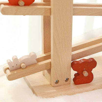 Close-up of a white rabbit block sliding down the bottom tier of a solid beech wooden flip track toy