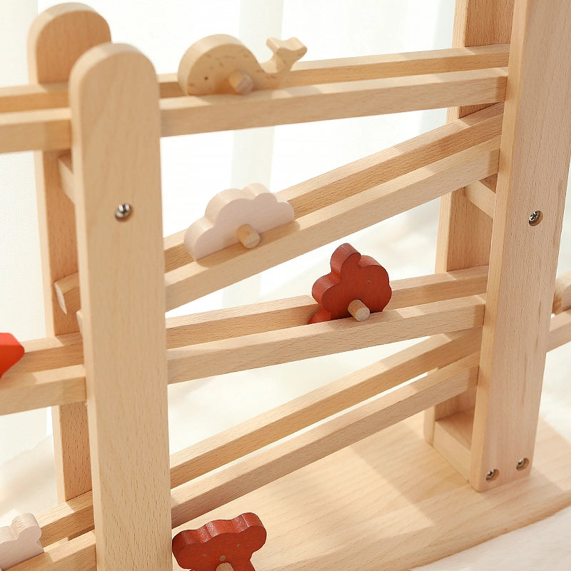 Close-up view of the upper tiers of a solid beech ramp track holding several wooden animal blocks
