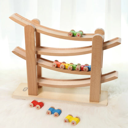 Side-angled view of a Montessori wooden car ramp toy showing cars cascading down the beech tracks