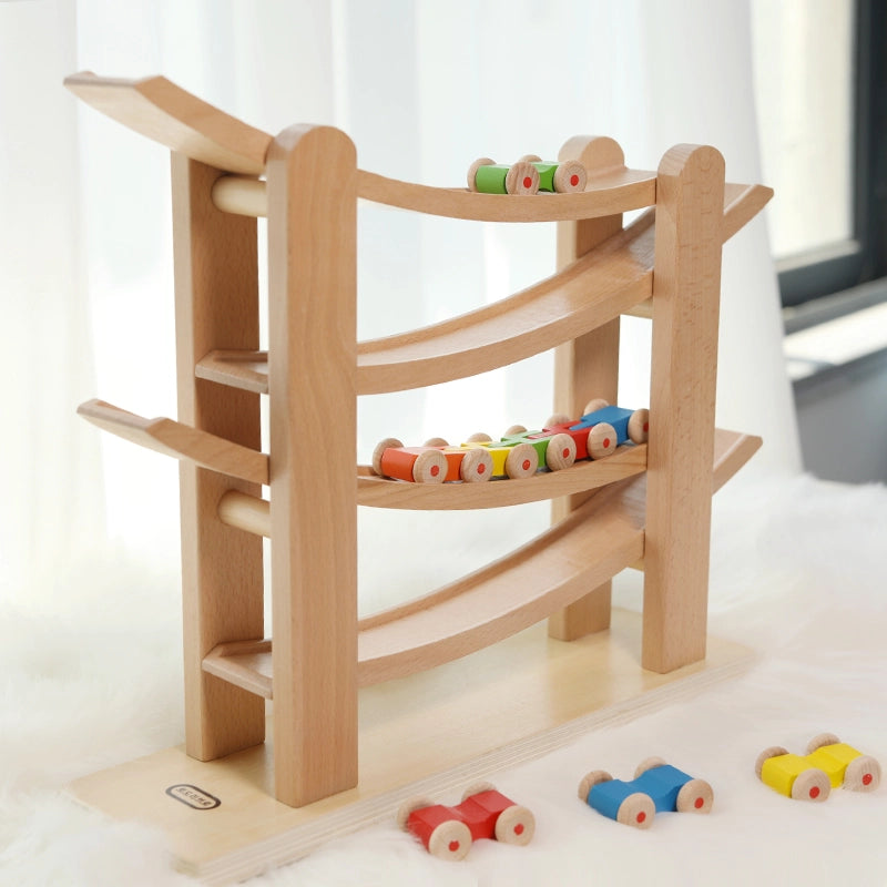 Three-quarter view of a Montessori wooden car ramp toy made of solid beech with colorful toy cars