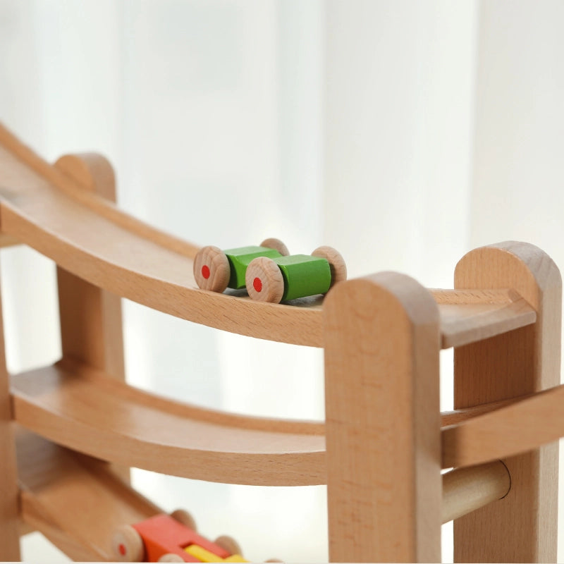 Close-up of a green toy car rolling on the track of a solid beech wooden car ramp toy