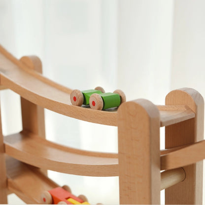 Close-up of a green toy car rolling on the track of a solid beech wooden car ramp toy
