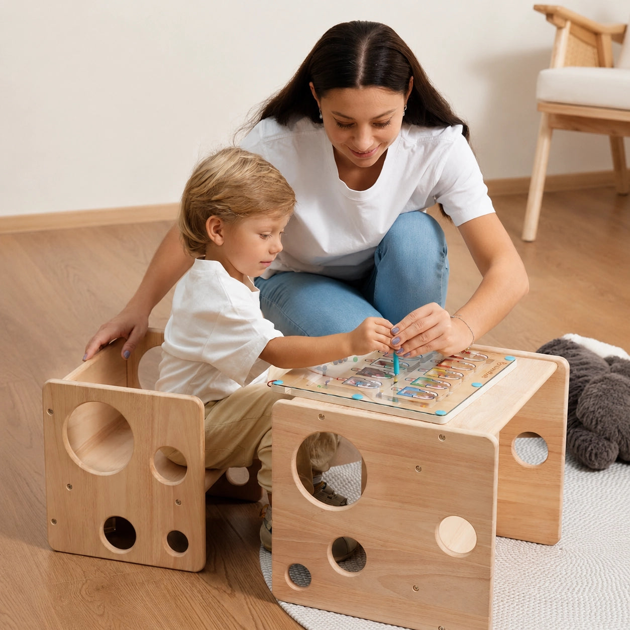 A young boy and mother using a solid rubber wood Montessori cube set as a desk and chair for an activity