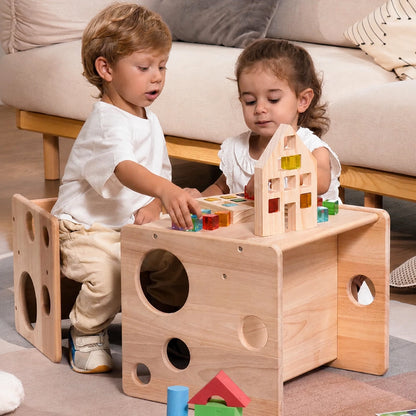 Two young children sitting together using a solid rubber wood Montessori cube set to play with building blocks