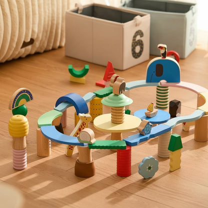 Angled view of an open-ended building blocks set built into a track structure with animal shapes on a wooden floor