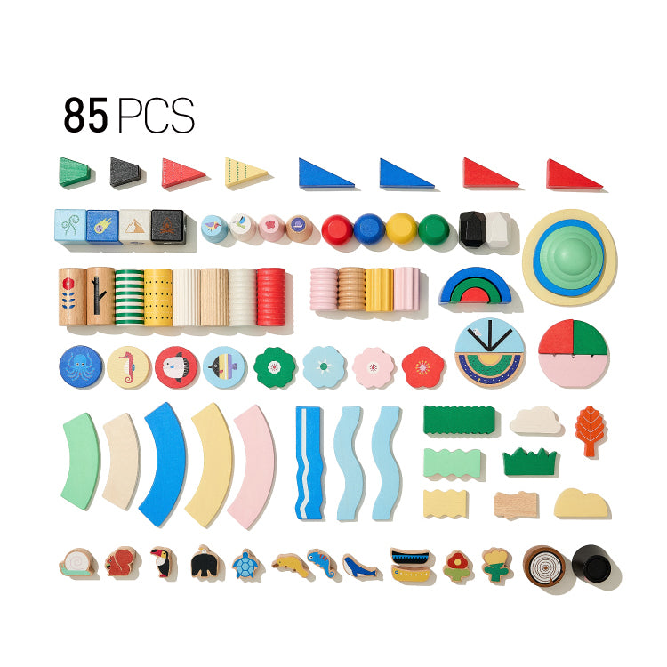 Flat lay of an 85-piece solid beech wood building blocks set with varied shapes and patterns on a white background