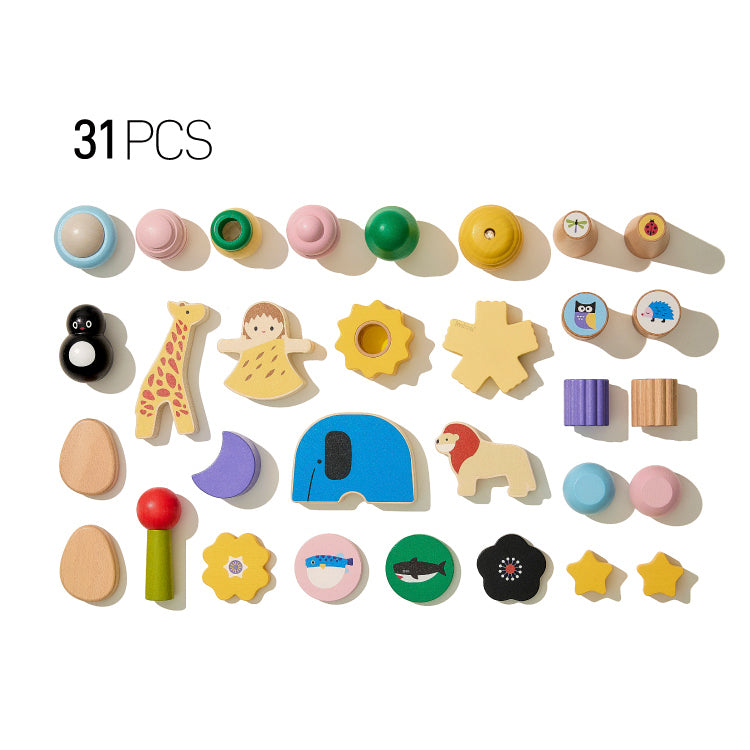 Flat lay of a 31-piece solid beech wood building blocks set with animal and geometric shapes on a white background