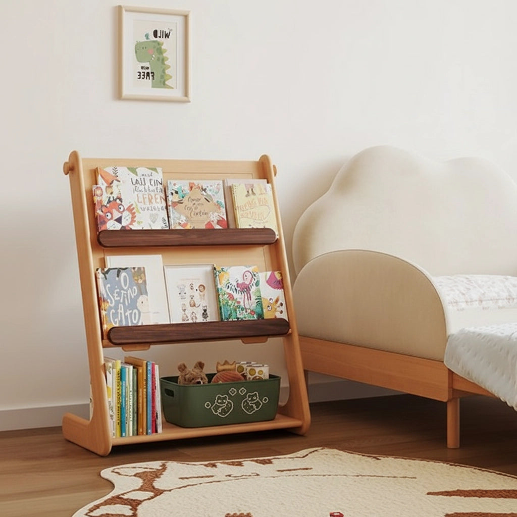 Three-quarter view of the front-facing bookshelf side filled with children's books next to a toddler bed
