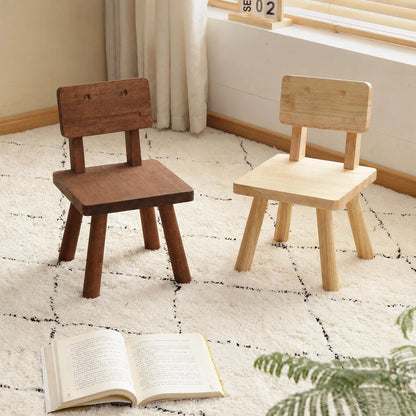 Front view of two solid rubber wood robot toddler chairs in natural and dark finishes on a white rug