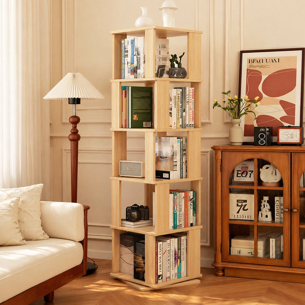 Angled view of a solid pine rotating kids bookshelf filled with books next to a white sofa
