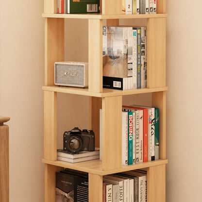 Close-up of shelves on a solid pine rotating bookshelf holding books, a speaker, and a camera