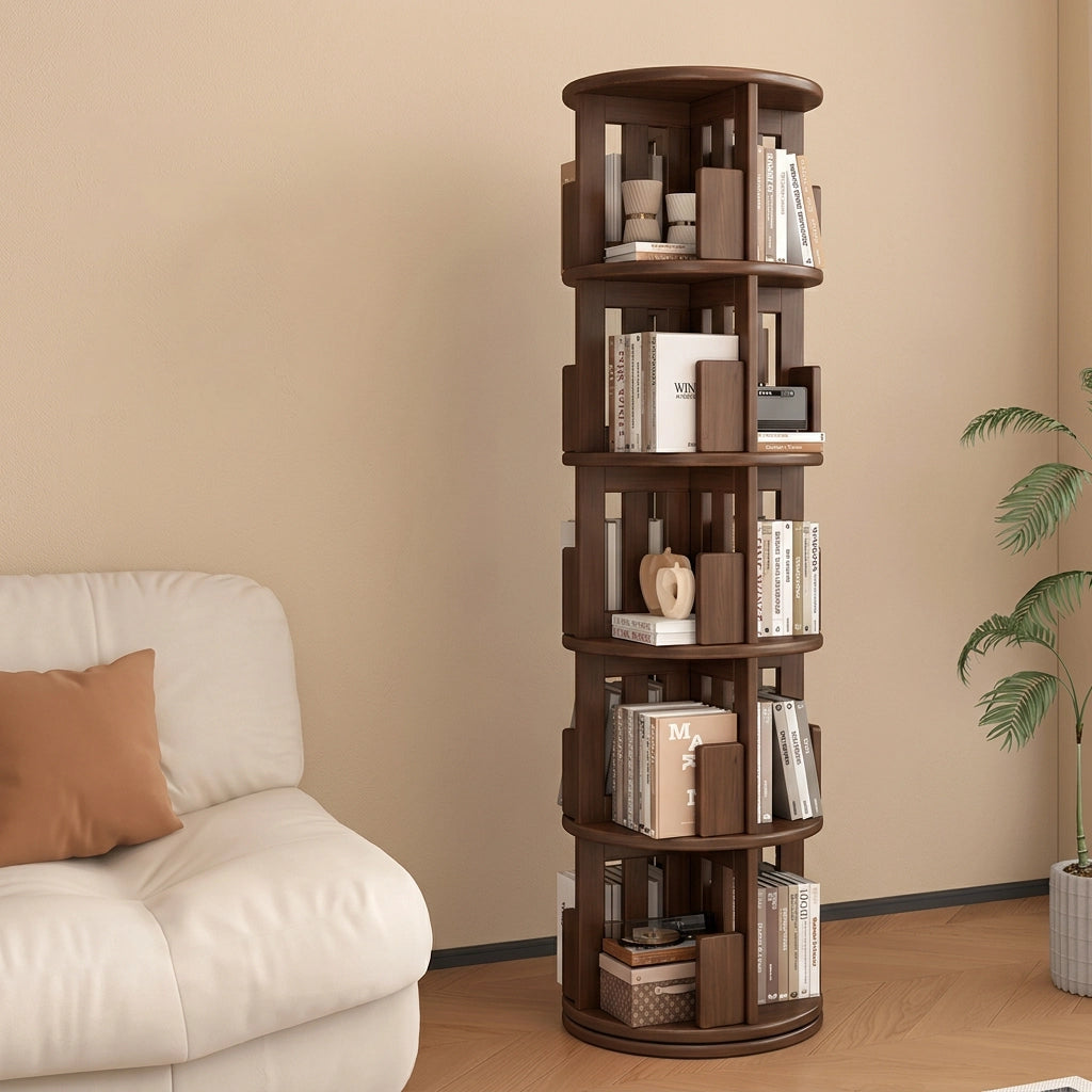 Angled view of a five-tier rotating kids bookshelf in a dark brown finish standing next to a white sofa