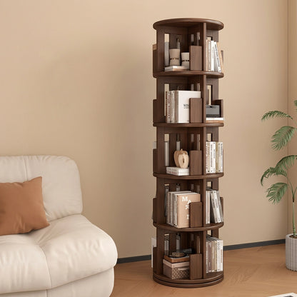 Angled view of a five-tier rotating kids bookshelf in a dark brown finish standing next to a white sofa
