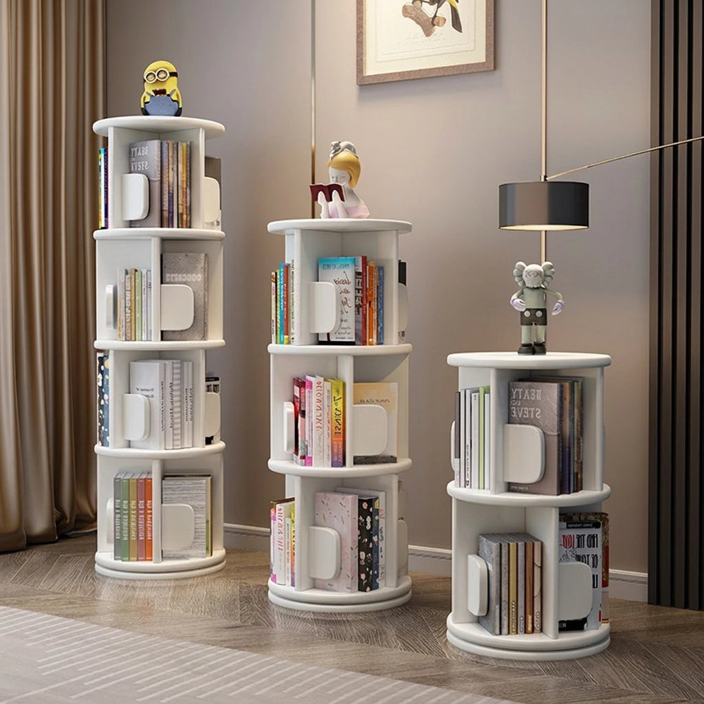 Three rotating solid wood kids bookshelves in a white finish and varying heights filled with picture books