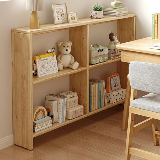 Right-angled view of a solid pine slim console bookshelf with compartments holding books and toys