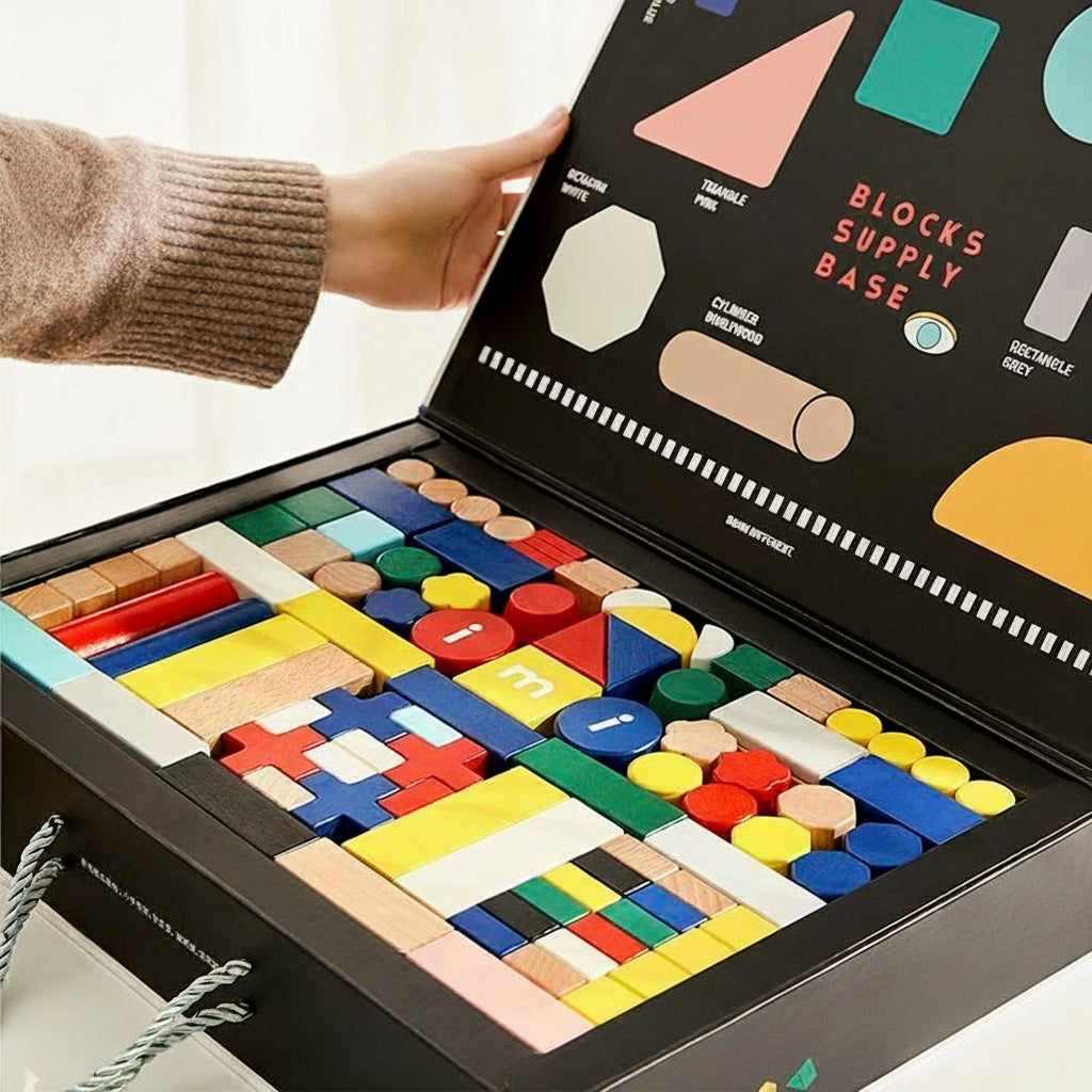 Angled view of a hand opening the storage box to reveal neatly sorted colorful wooden blocks inside