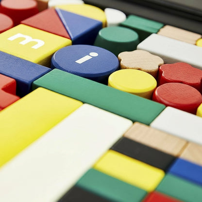 Extreme close-up of colorful building blocks showing letter details and smooth natural wood textures