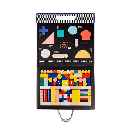 Open box view showing neatly arranged colorful solid beech wood blocks with a shape diagram on the inner lid