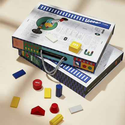 Two illustrated carrying cases stacked together with several colorful solid beech wood blocks scattered around