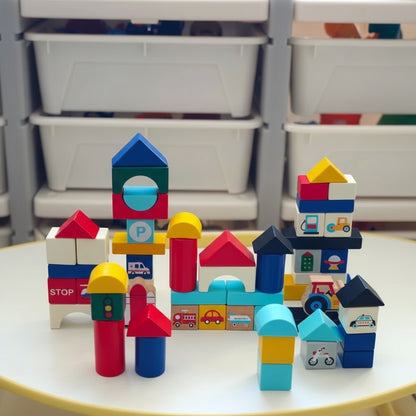 Stacked block structures from the toddler building blocks set arranged on a table in front of storage bins