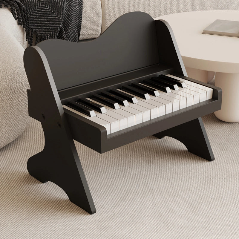 Three-quarter view of a plywood toddler electronic piano with a matte black finish on a rug