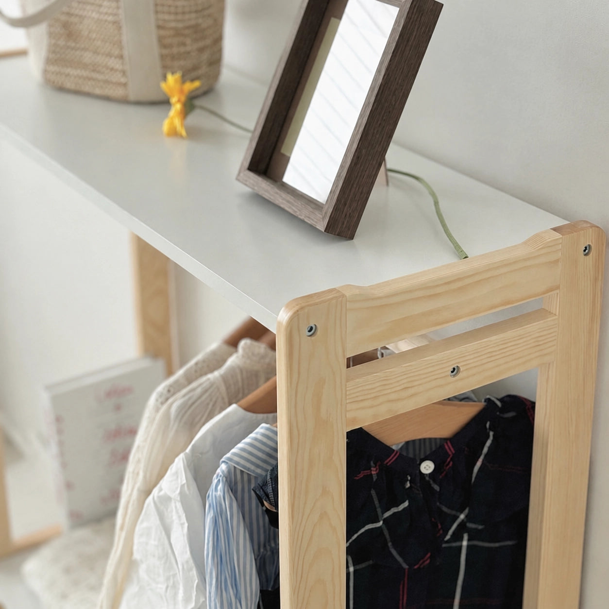 Close-up view of the top shelf structure and wood grain joints on the solid pine garment rack