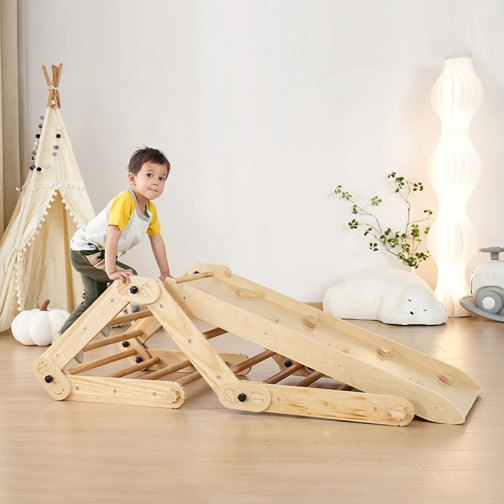 Toddler boy climbing up a wooden rock ramp attached to a pine and plywood Montessori climbing set