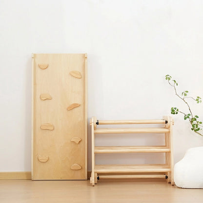 Folded pine and plywood climbing set components stacked vertically against a wall for compact storage