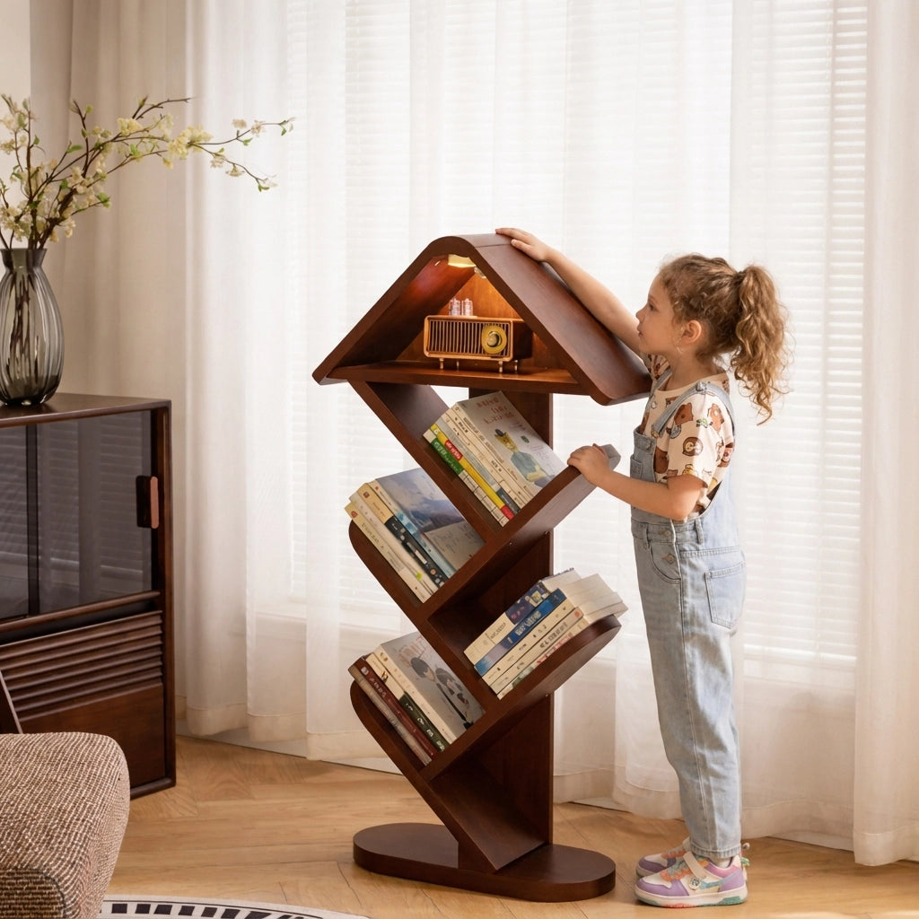 Little girl standing next to a solid rubber wood tree shape floor bookshelf filled with books