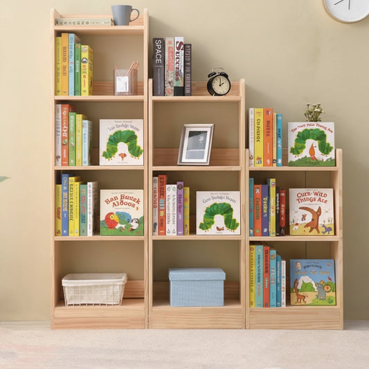 Front view of three solid pine vertical kids bookcases arranged in a descending stepped layout filled with books