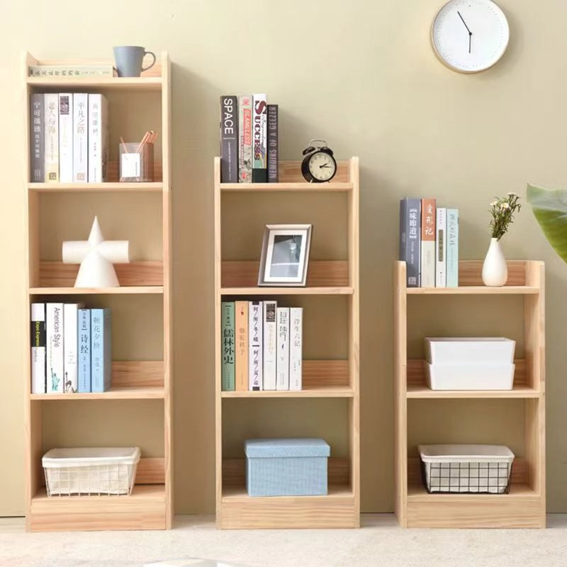 Descending vertical kids bookcases filled with white-covered books, organizers, and a small decorative vase